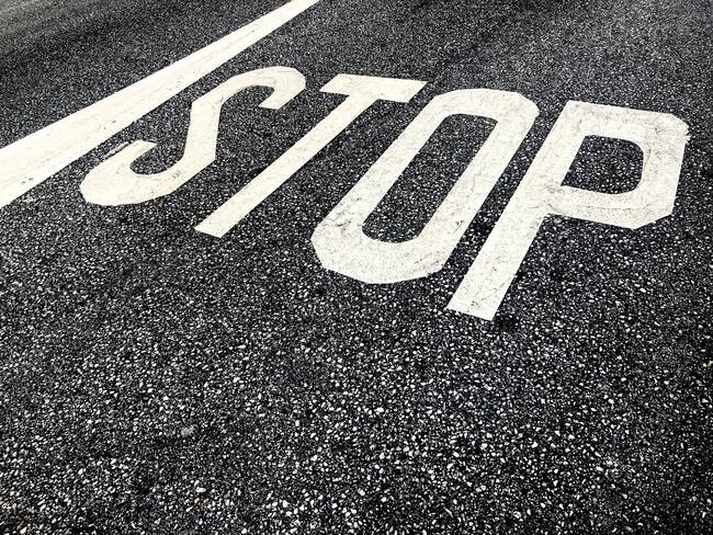 High Angle View Of Stop Marking On Wet Street