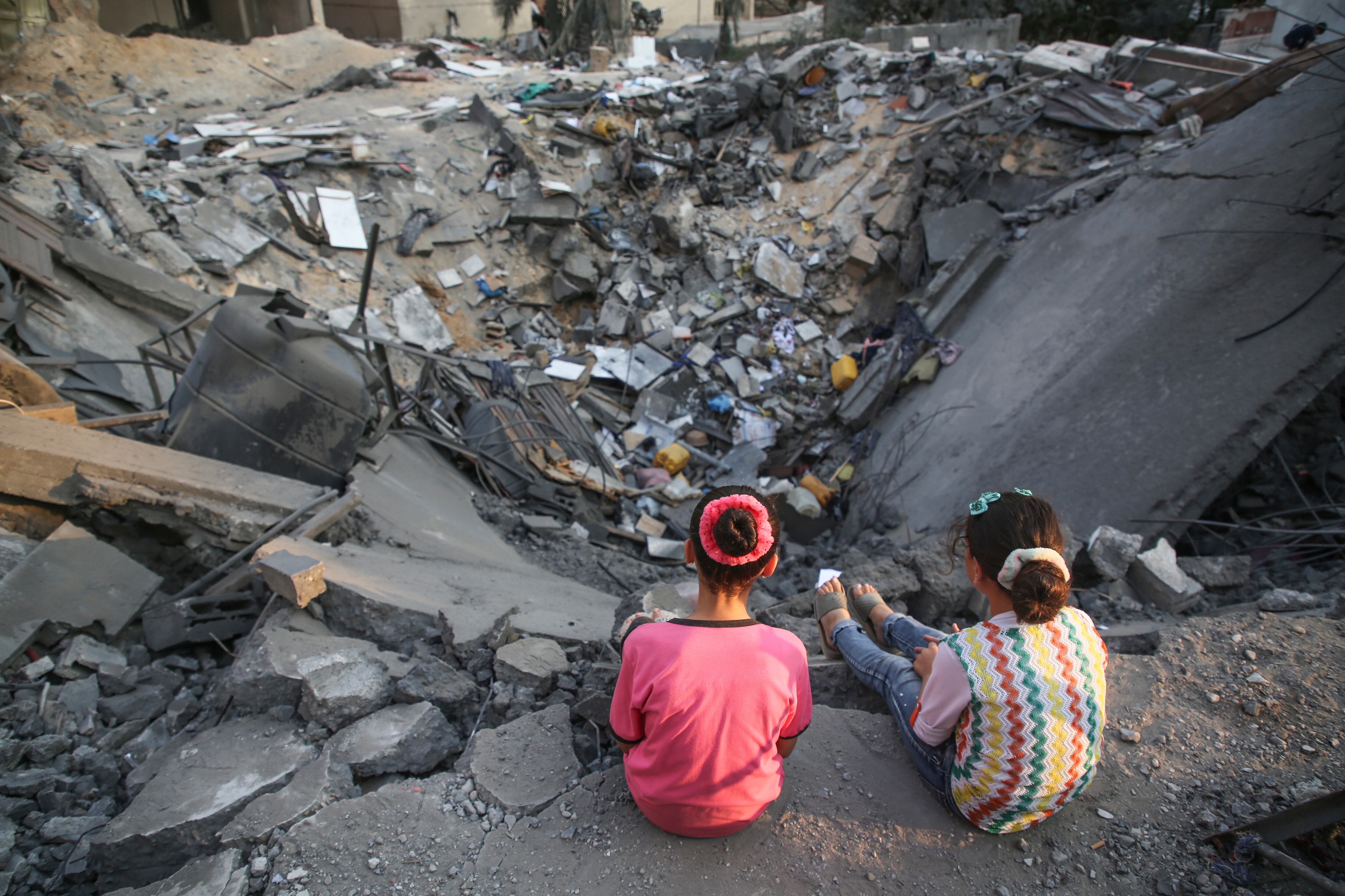 Niños palestinos inspeccionan su edificio dañado en la ciudad de Gaza el 9 de agosto de 2022 después de que entró en vigor un alto el fuego entre Israel y los militantes palestinos. (Photo by Majdi Fathi/NurPhoto via Getty Images)