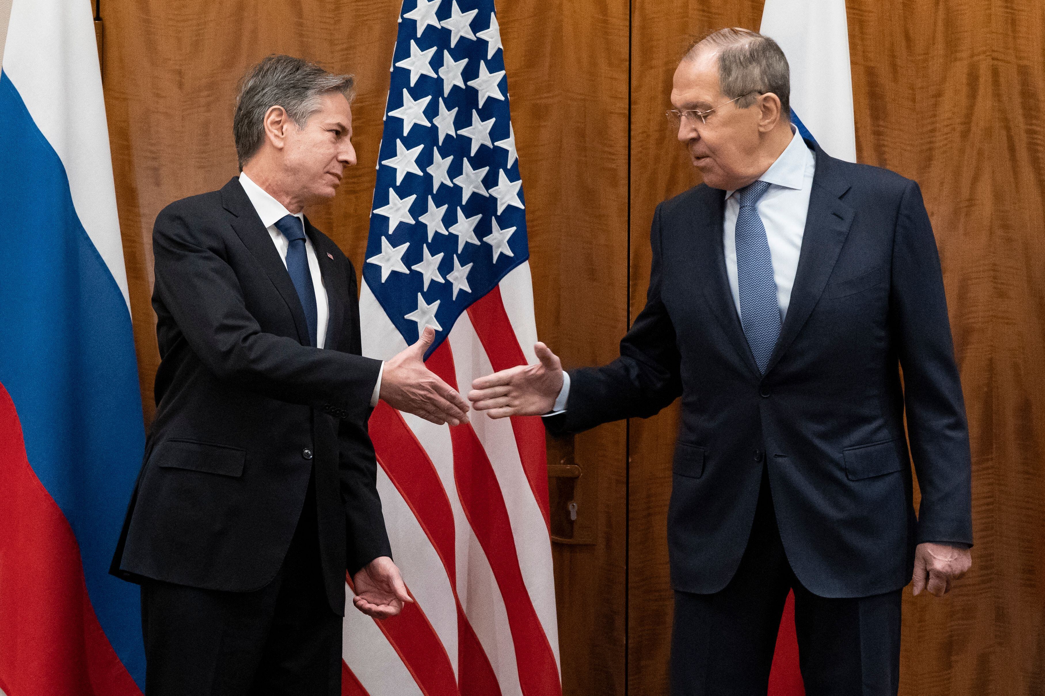 TOPSHOT - US Secretary of State Antony Blinken (L) greets Russian Foreign Minister Sergey Lavrov before their meeting, in Geneva, on January 21, 2022. - Washington and Moscow's top diplomats meet in Geneva in a last-ditch bid for a solution over Ukraine, with the United States increasingly fearing that Russia will invade despite warnings of severe reprisals. (Photo by Alex Brandon / POOL / AFP) (Photo by ALEX BRANDON/POOL/AFP via Getty Images)