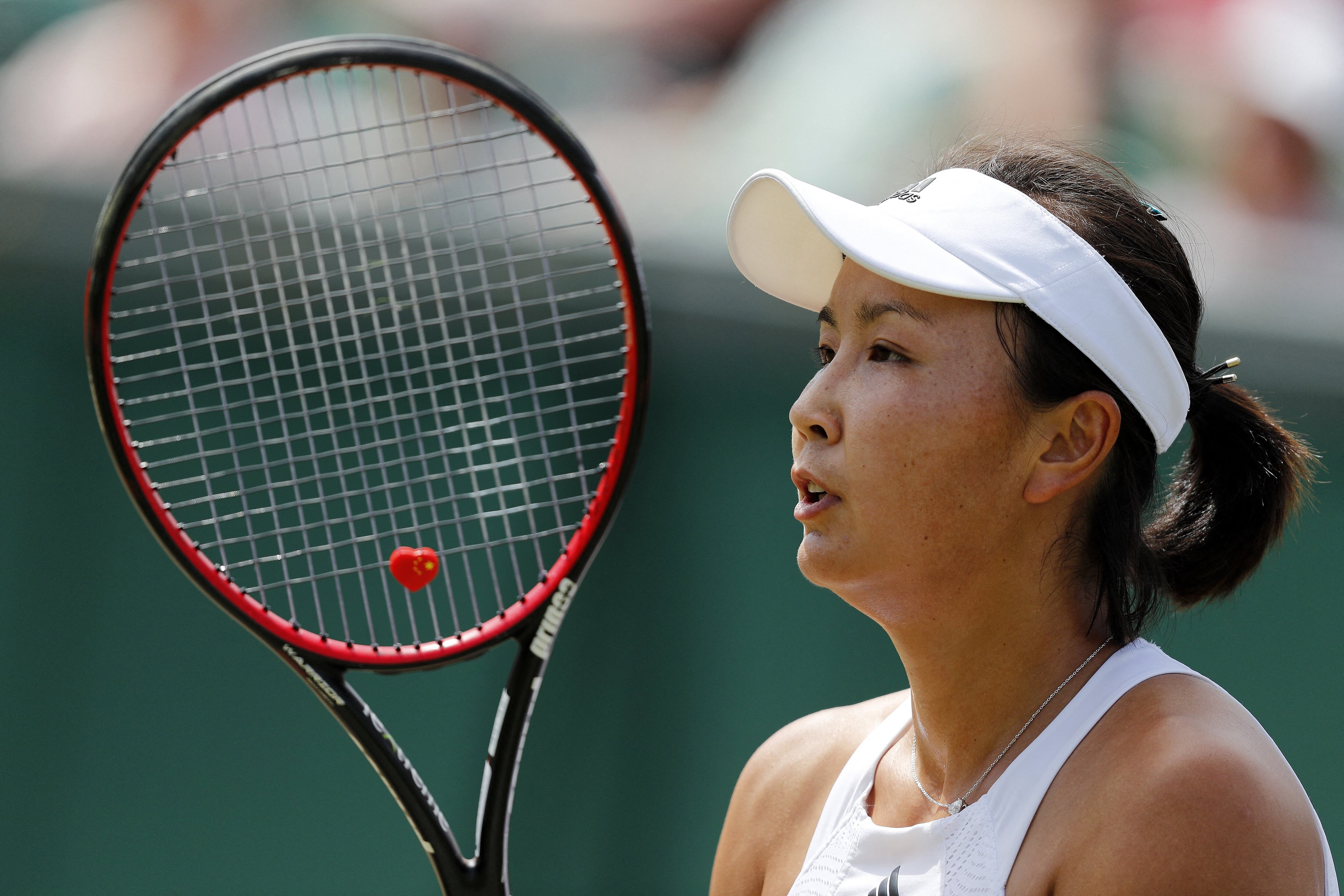 (FILES) This file photo taken on July 7, 2017 shows China's Peng Shuai Romania's reacting against Simona Halep during their women's singles third round match on the fifth day of the 2017 Wimbledon Championships at The All England Lawn Tennis Club in Wimbledon, southwest London. - China's former vice premier Zhang Gaoli (2013-18) has been accused by tennis champion Peng Shuai of forcing her to have sex during a long-term on-off relationship, in a message promptly censored on Chinese social networks. (Photo by Adrian DENNIS / AFP) / TO GO WITH Tennis-CHN-China-politics-Zhang,PROFILE by Patrick BAERTRESTRICTED TO EDITORIAL USE