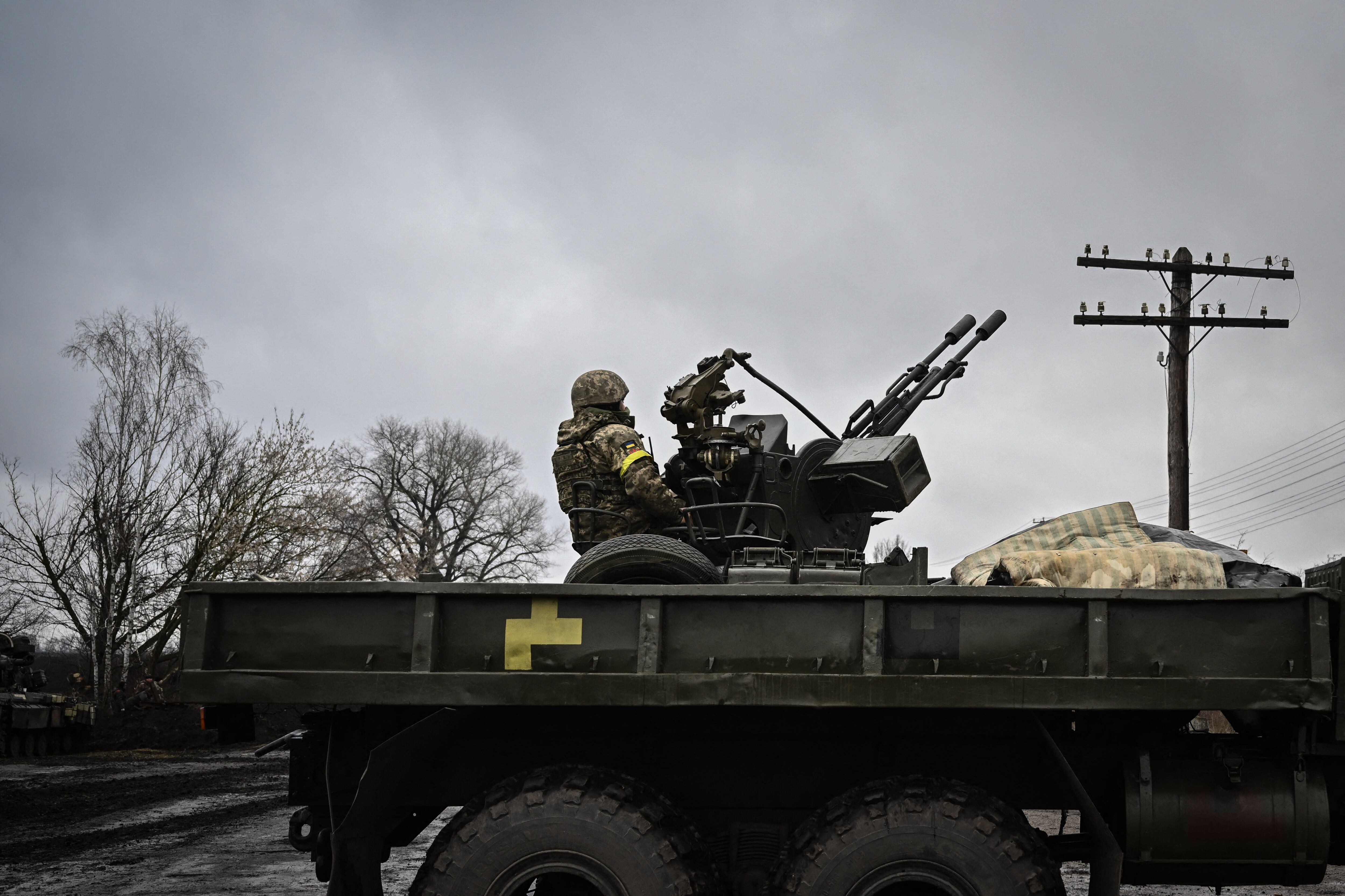 An Ukrainian soldier keeps position sitting on a ZU-23-2 anti-aircraft gun at a frontline, northeast of Kyiv on March 3, 2022. - A Ukrainian negotiator headed for ceasefire talks with Russia said on March 3, 2022, that his objective was securing humanitarian corridors, as Russian troops advance one week into their invasion  of the Ukraine. (Photo by Aris Messinis / AFP) (Photo by ARIS MESSINIS/AFP via Getty Images)