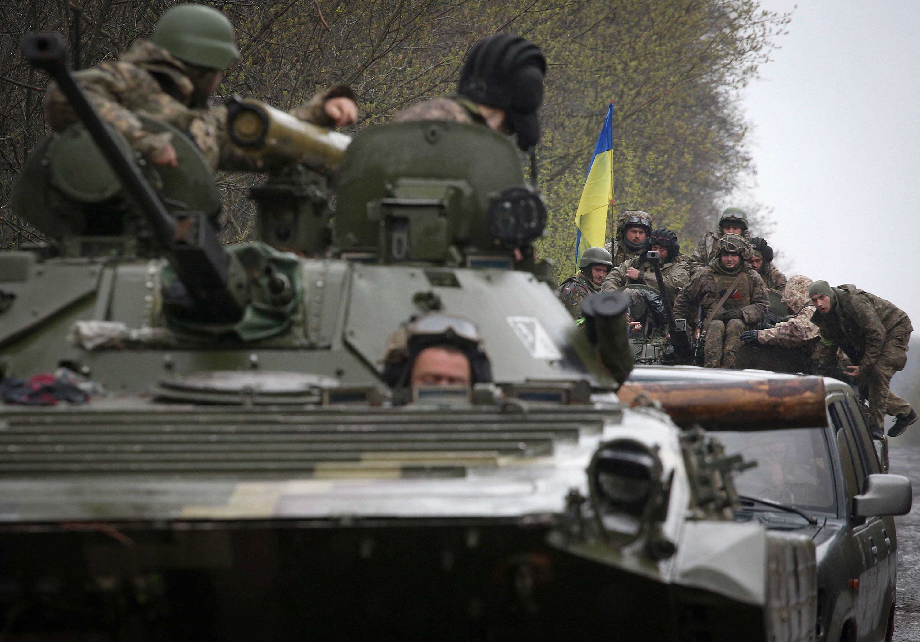 Ukrainian soldiers stand on their armoured personnel carrier (APC), not far from the front-line with Russian troops, in Izyum district, Kharkiv region on April 18, 2022, during the Russian invasion of Ukraine. (Photo by Anatolii Stepanov / AFP) (Photo by ANATOLII STEPANOV/AFP via Getty Images)