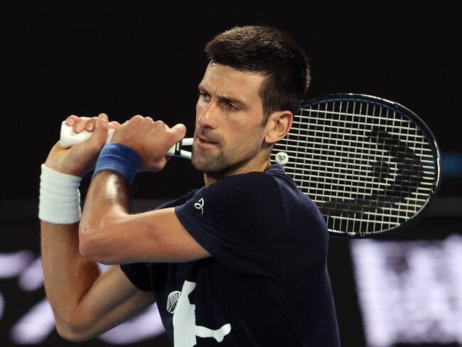 Novak Djokovic of Serbia attends a practice session ahead of the Australian Open tennis tournament in Melbourne on January 14, 2022. - --IMAGE RESTRICTED TO EDITORIAL USE - NO COMMERCIAL USE-- (Photo by MARTIN KEEP / AFP) / --IMAGE RESTRICTED TO EDITORIAL USE - NO COMMERCIAL USE-- (Photo by MARTIN KEEP/AFP via Getty Images)