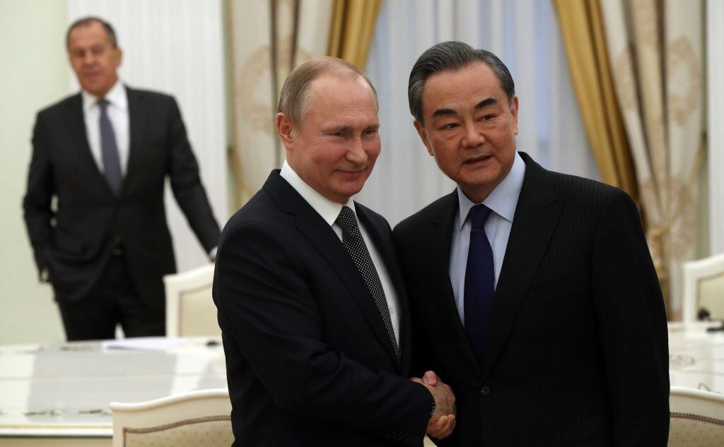 MOSCOW, RUSSIA - APRIL 5: (RUSSIA OUT) Russian President Vladimir Putin (C) greets Chinese Foreign Minister Wang Yi (Photo by Mikhail Svetlov/Getty Images)