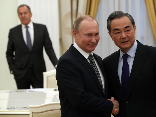 MOSCOW, RUSSIA - APRIL 5: (RUSSIA OUT) Russian President Vladimir Putin (C) greets Chinese Foreign Minister Wang Yi (Photo by Mikhail Svetlov/Getty Images)