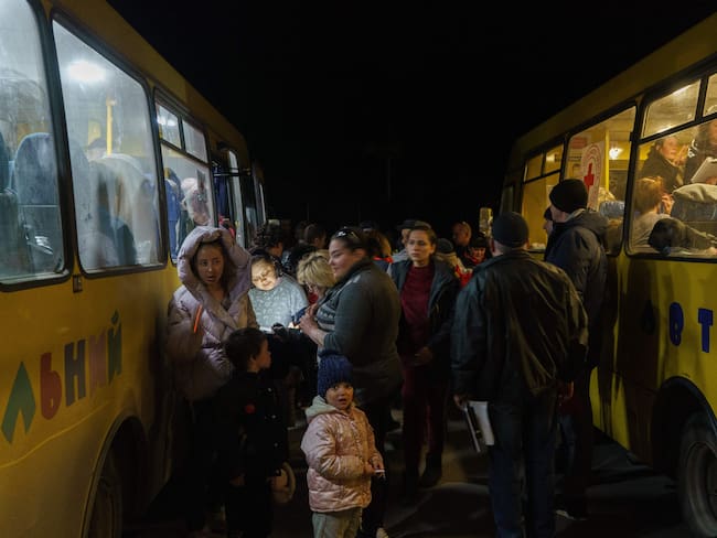 Women and children disembark as a convoy of 30 buses carrying evacuees from Mariupol and Melitopol arrive at the registration center in Zaporizhzhia, on April 1, 2022. - Late on April 1, people who managed to flee Mariupol to Russian-occupied Berdiansk were from there carried on dozens of buses to Zaporizhzhia, some 200 kilometers (120 miles) to the northwest, according to an AFP reporter on the scene. (Photo by emre caylak / AFP) (Photo by EMRE CAYLAK/AFP via Getty Images)