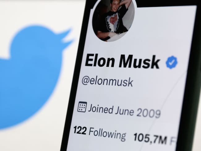Elon Musk's Twitter profile displayed on a phone screen and Twitter logo displayed on a screen are seen in this illustration photo taken in Krakow, Poland on September 15, 2022. (Photo by Jakub Porzycki/NurPhoto via Getty Images)