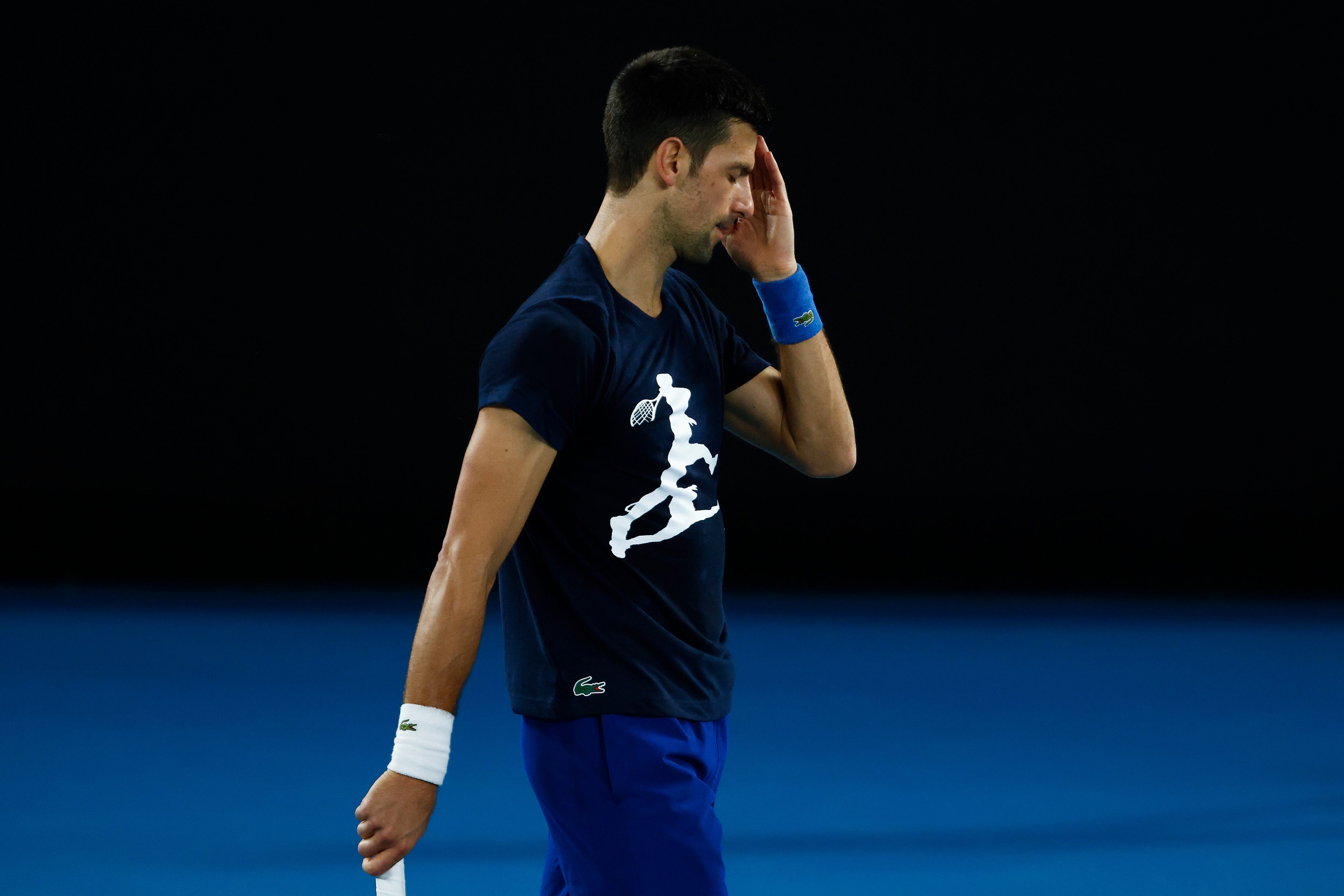 MELBOURNE, AUSTRALIA - JANUARY 14: Novak Djokovic of Serbia reacts during a practice session ahead of the 2022 Australian Open at Melbourne Park on January 14, 2022 in Melbourne, Australia. (Photo by Daniel Pockett/Getty Images)