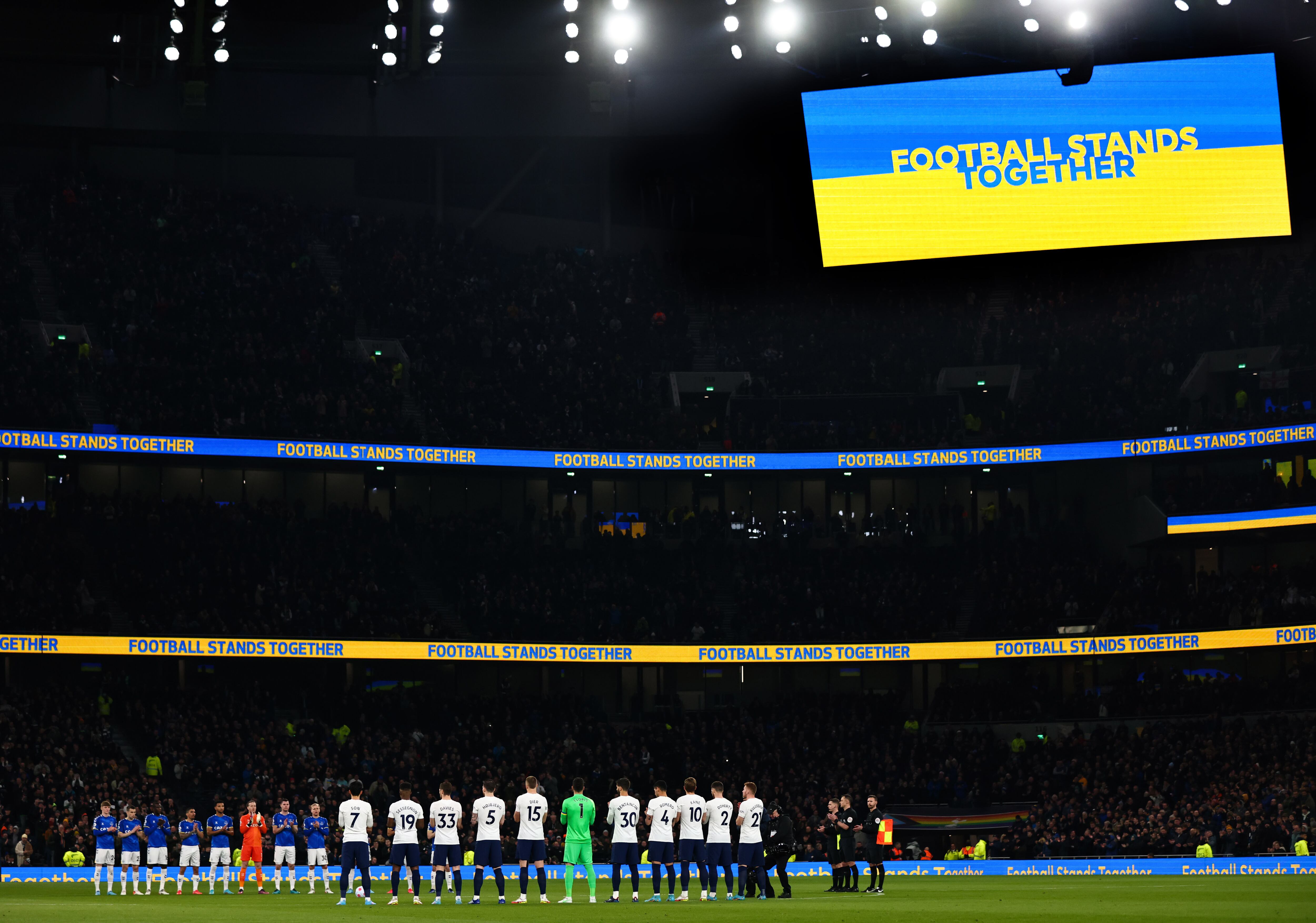 LONDON, ENGLAND - MARCH 07:  Players and officials applaud as the LED screen displays a Football Stands Together message to indicate peace and sympathy with Ukraine prior to the Premier League match between Tottenham Hotspur and Everton at Tottenham Hotspur Stadium on March 7, 2022 in London, United Kingdom. (Photo by Marc Atkins/Getty Images)