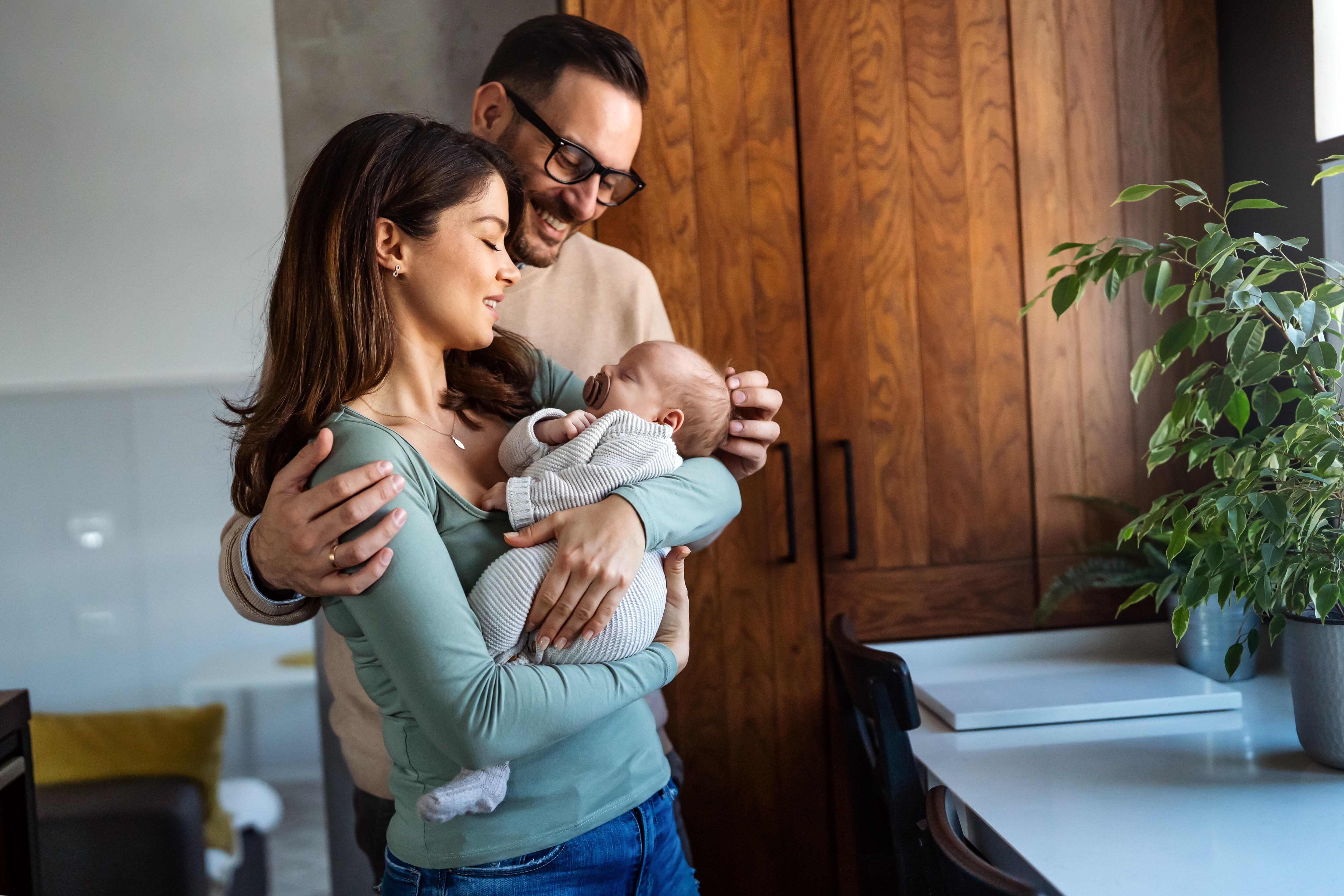 Padres cuidando en casa a su bebé recién nacido (Foto vía GettyImages)