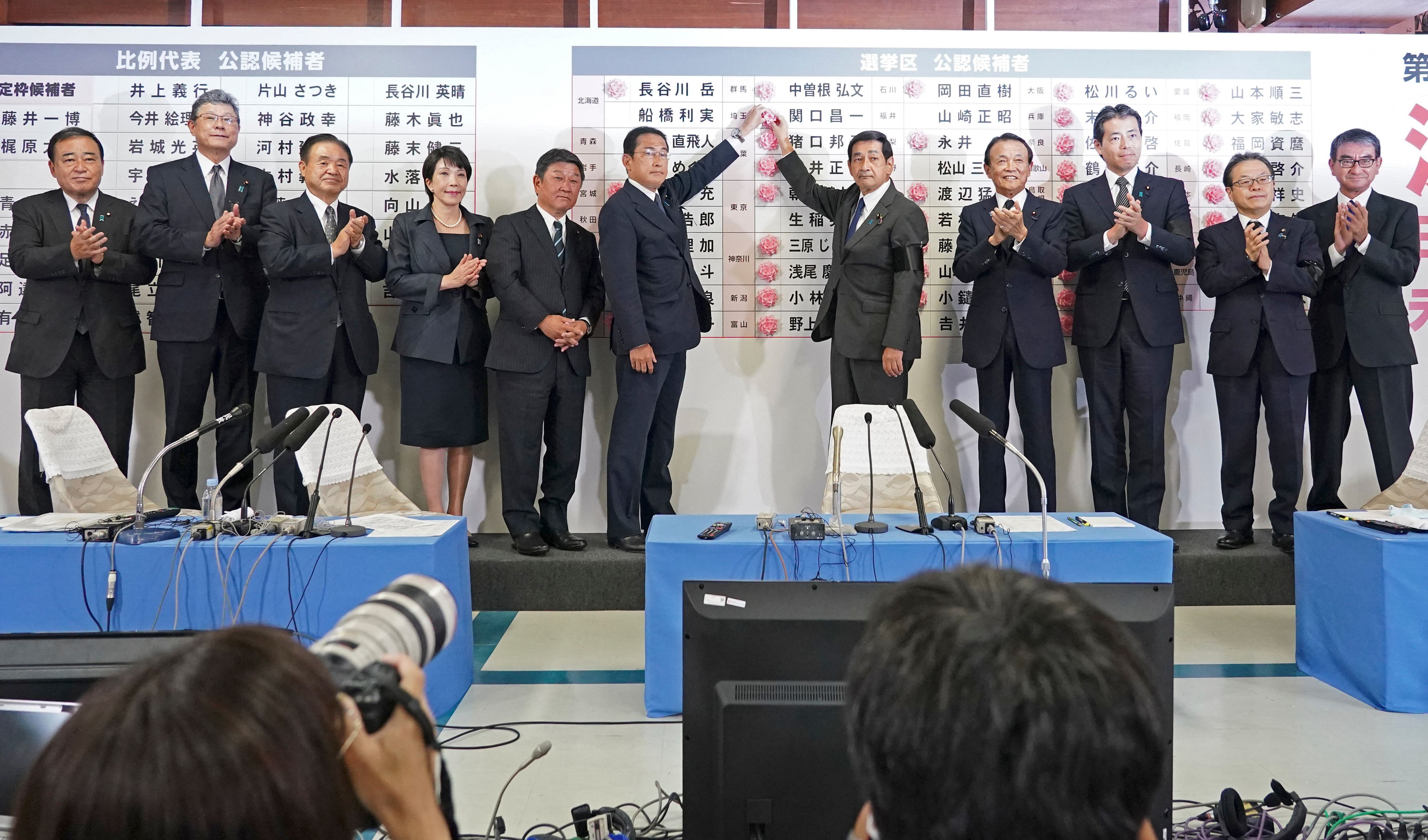 Japan's Prime Minister and the President of the Liberal Democratic Party (LDP) Fumio Kishida (center L) places a red paper rose on a LDP candidate's name to indicate the victory in the upper house election, along with his party executives at the party's headquarters in Tokyo on July 10, 2022. (Photo by TORU HANAI / POOL / AFP) (Photo by TORU HANAI/POOL/AFP via Getty Images)