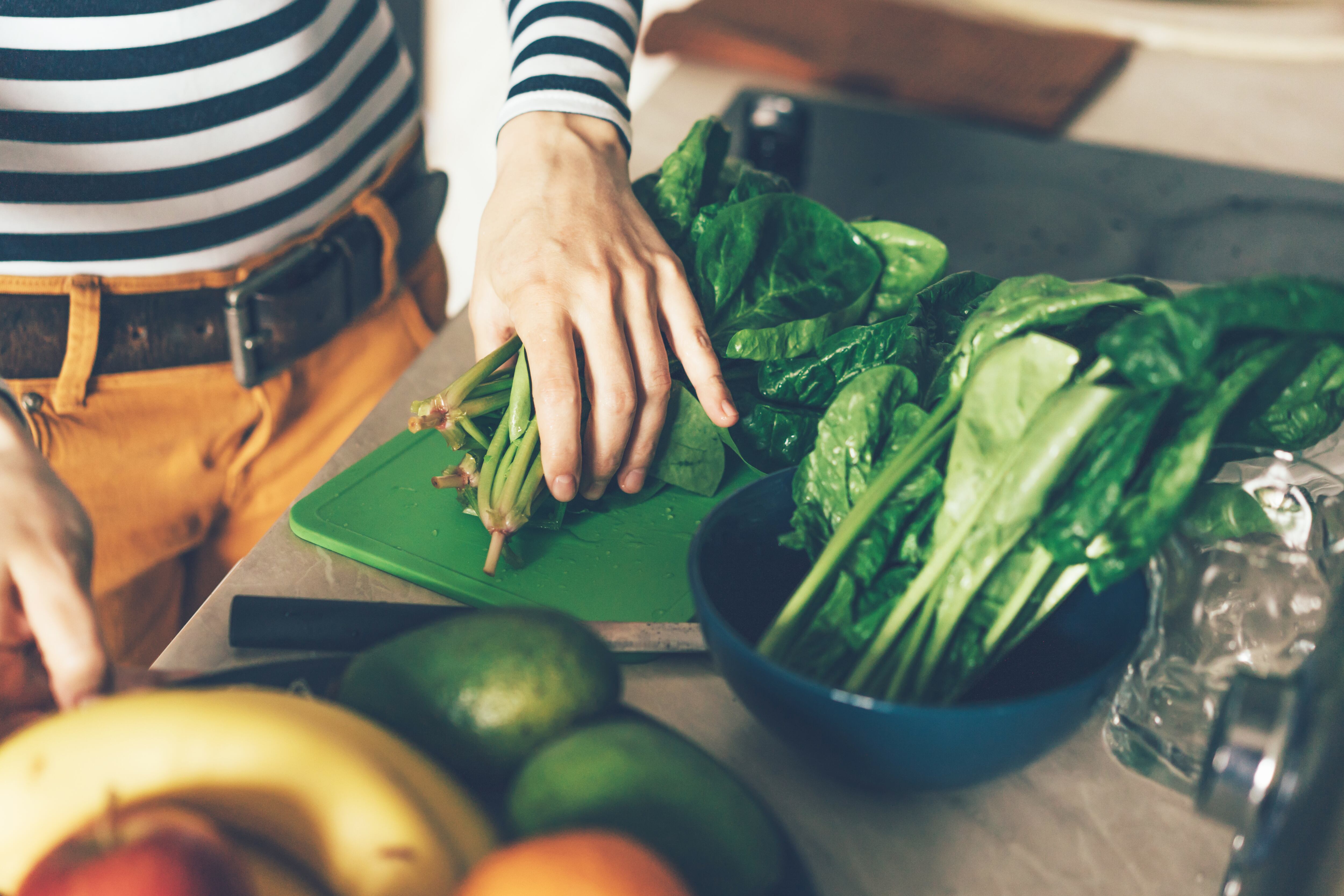 Persona preparando comida con vegetales (Foto vía Getty Images)