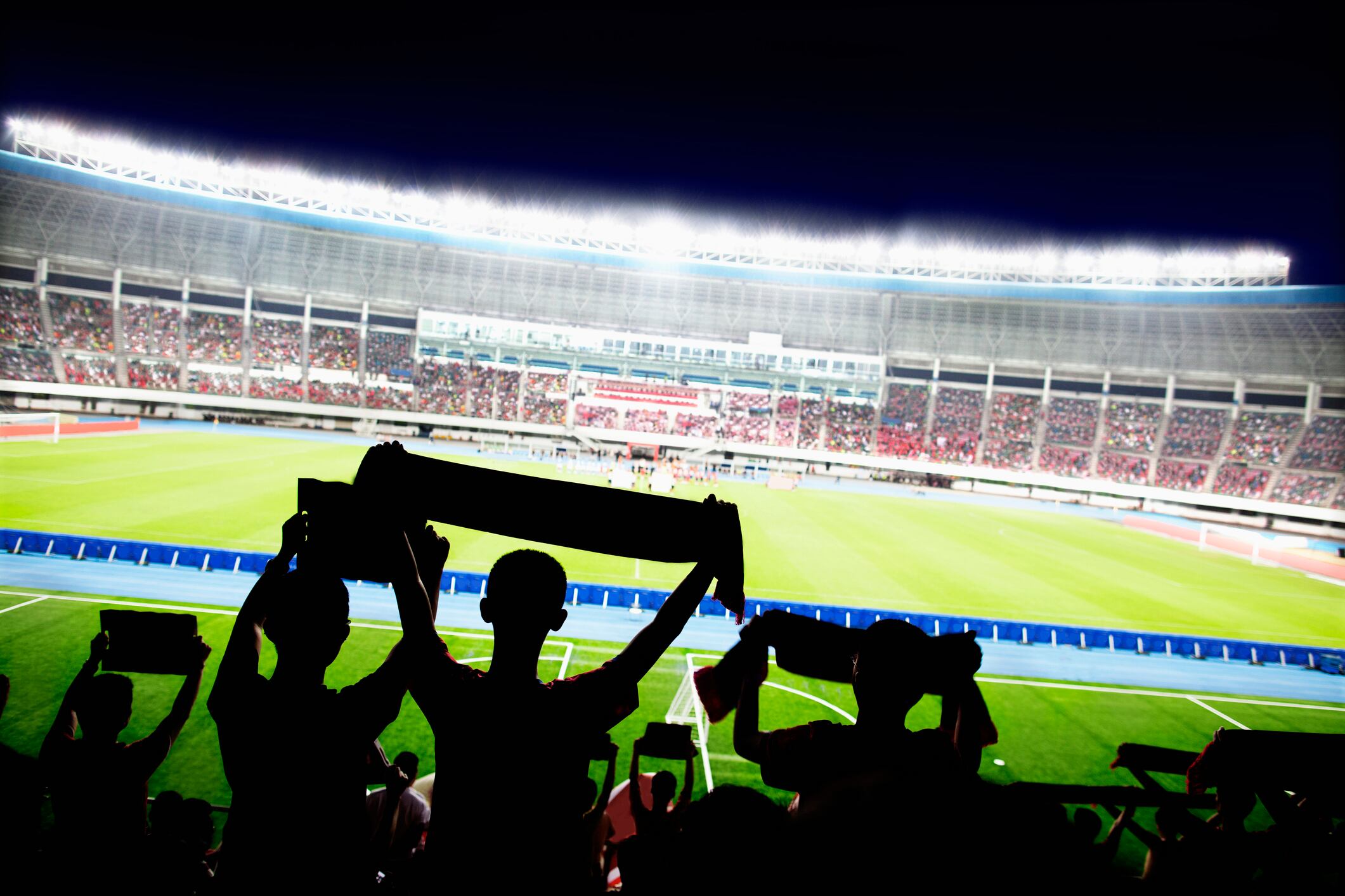 Passionate fans cheer and raise banners at a sporting event in the stadium
