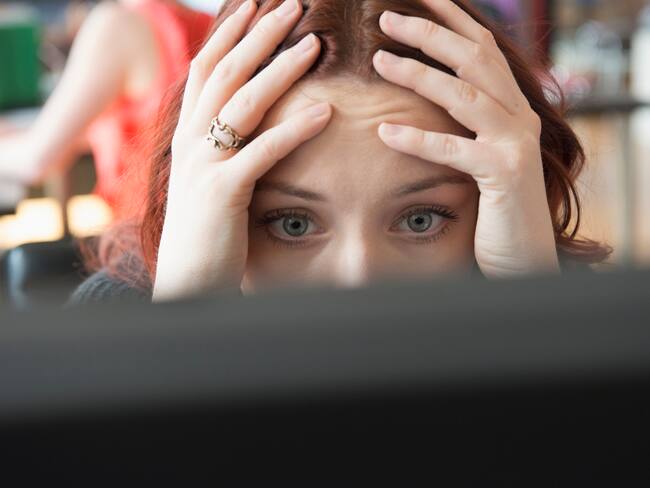 Frustrated Caucasian businesswoman using computer