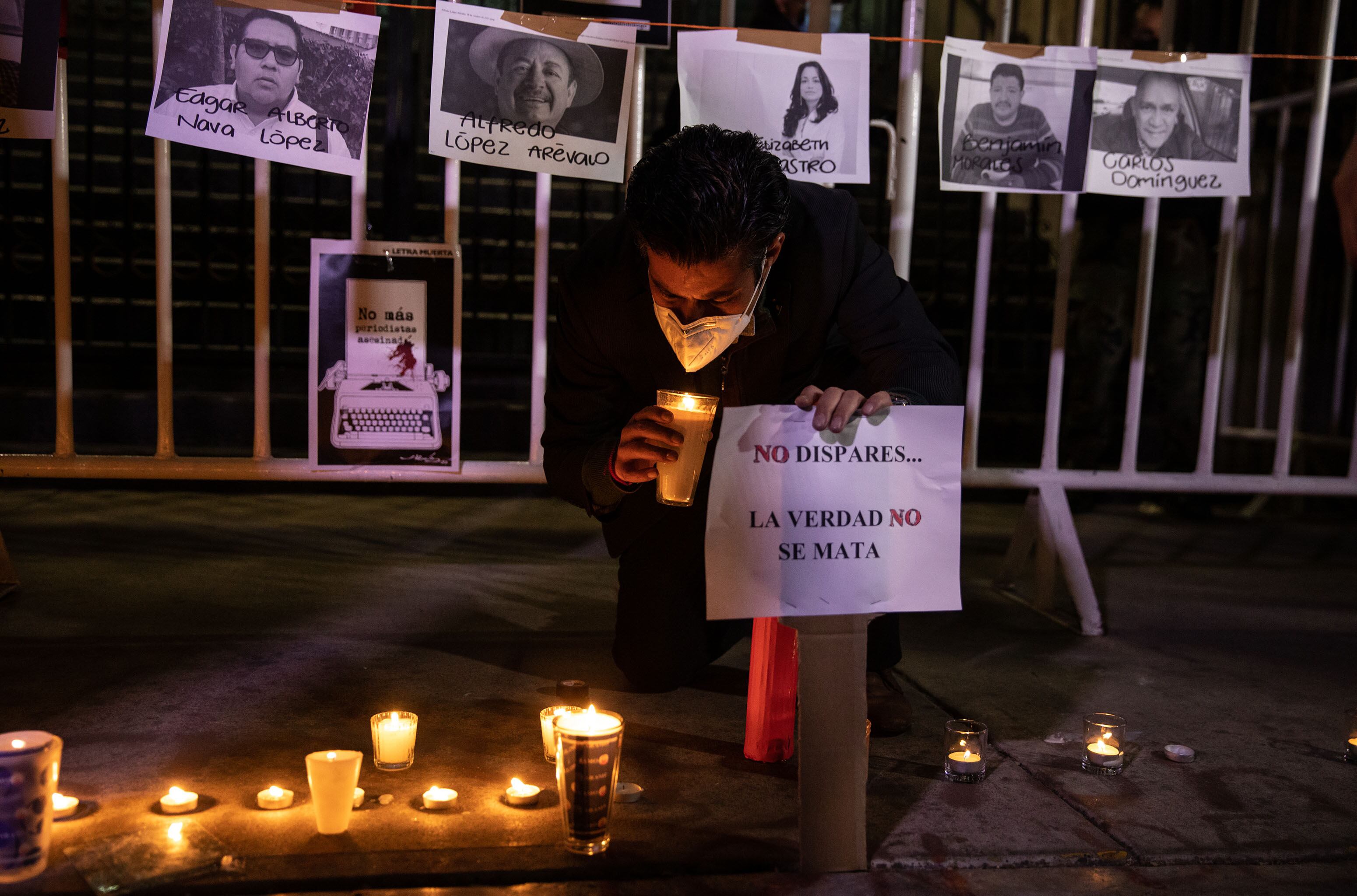 MEXICO CITY, MEXICO -  JANUARY 25: A journalist holds a candle during a protest to demand justice for murders of colleagues, in front of the Interior Ministry Office, in Mexico City, Mexico on January 25, 2022. Journalist Lourdes Maldonado Lopez was found shot to death in her car outside her home in the northern city of Tijuana, marking the third killing of a journalist in the country just this year. (Photo by Daniel Cardenas/Anadolu Agency via Getty Images)