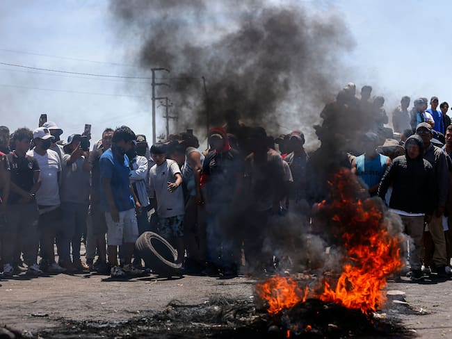 Los manifestantes bloquean la carretera Panamericana exigiendo la renuncia de la presidenta de Perú, Dina Boluarte, en Ica, sur de Perú, el 6 de enero de 2023. Foto de HUGO CUROTTO/AFP vía Getty Images.