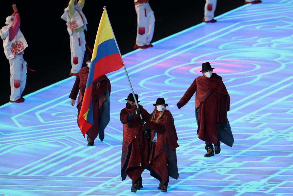 BEIJING, CHINA - FEBRUARY 04: Flag bearers Laura Gomez and Carlos Andres Quintana of Team Colombia lead their team out during the Opening Ceremony of the Beijing 2022 Winter Olympics at the Beijing National Stadium on February 04, 2022 in Beijing, China. (Photo by Ezra Shaw/Getty Images)