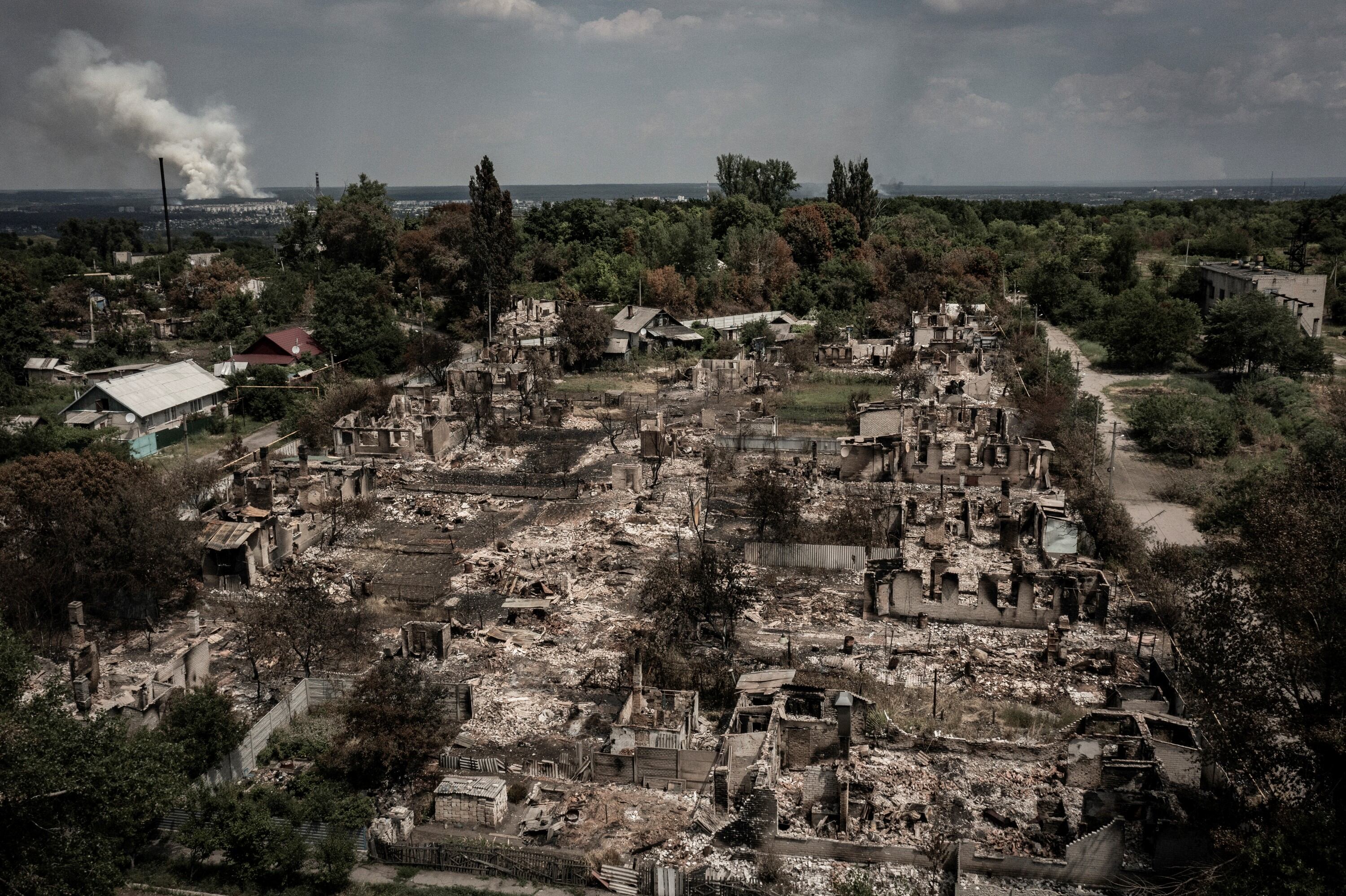 TOPSHOT - An aerial view shows destroyed houses after strike in the town of Pryvillya at the eastern Ukrainian region of Donbas on June 14, 2022, amid Russian invasion of Ukraine. - The cities of Severodonetsk and Lysychansk, which are separated by a river, have been targeted for weeks as the last areas still under Ukrainian control in the eastern Lugansk region. (Photo by ARIS MESSINIS / AFP) (Photo by ARIS MESSINIS/AFP via Getty Images)