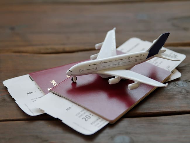 Toy Airplane With Passports and Flight booking ticket. Travel concept.