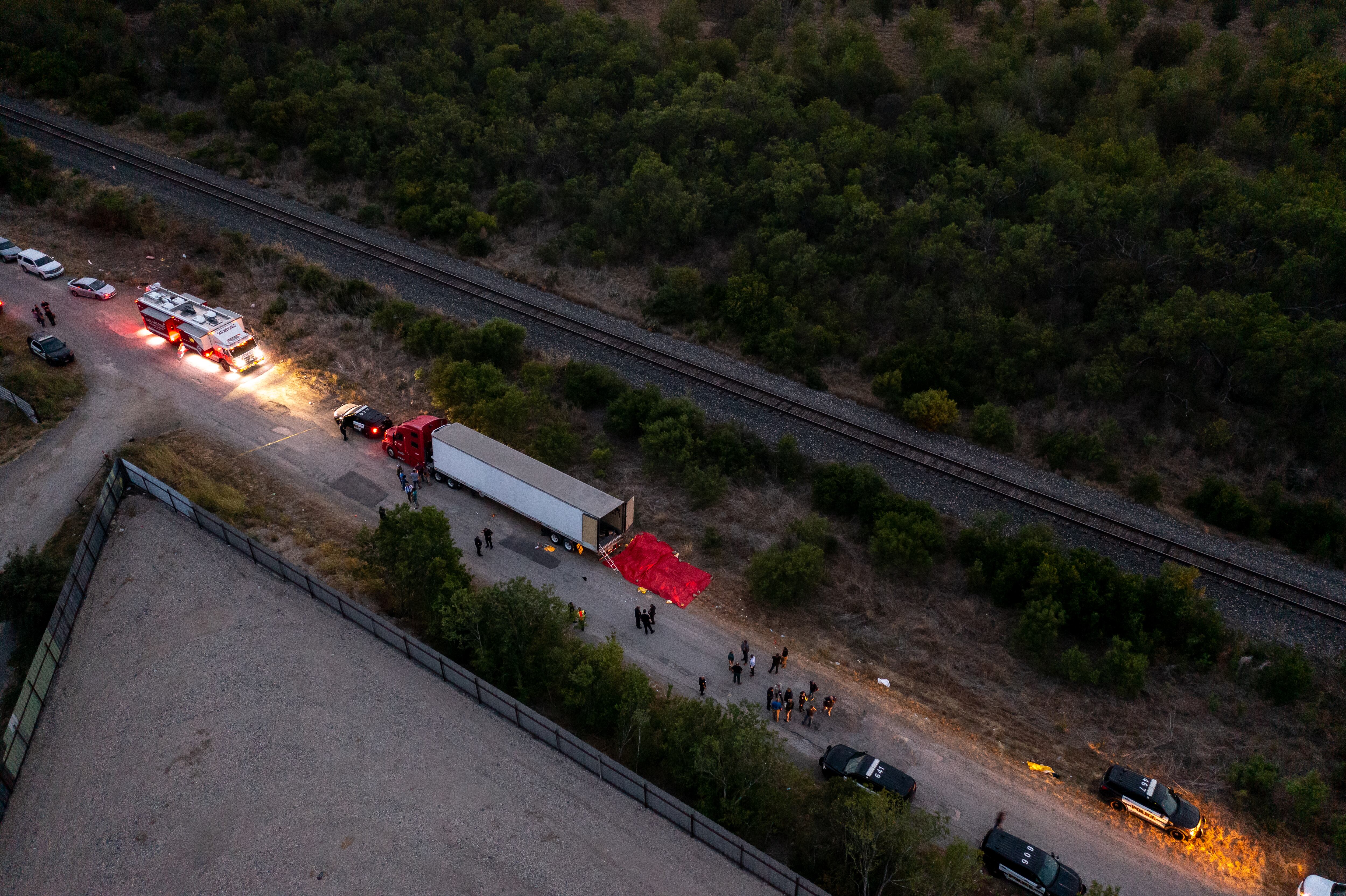 SAN ANTONIO, TX - JUNE 27: In this aerial view, members of law enforcement investigate a tractor trailer on June 27, 2022 in San Antonio, Texas. According to reports, at least 46 people, who are believed migrant workers from Mexico, were found dead in an abandoned tractor trailer. Over a dozen victims were found alive, suffering from heat stroke and taken to local hospitals. (Photo by Jordan Vonderhaar/Getty Images)