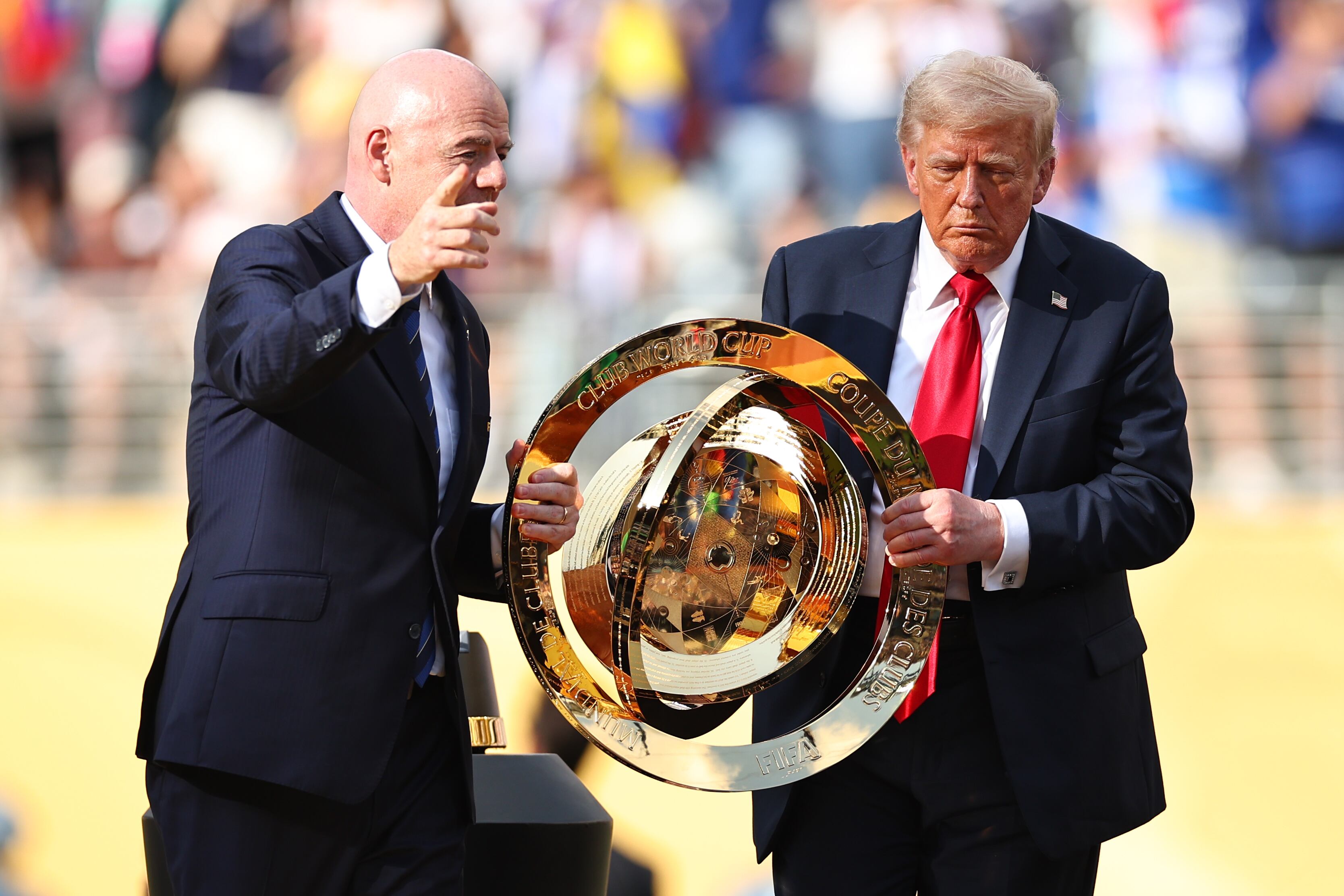 U.S. President Donald Trump and FIFA President Gianni Infantino hold the FIFA Club World Cup trophy during the FIFA Club World Cup 2025 final match. (Photo by Robbie Jay Barratt - AMA/Getty Images)