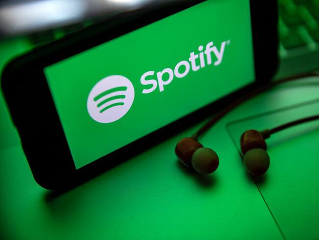 In this photo illustration the Spotify logo seen displayed on a smartphone screen near a pair of earphones. (Photo Illustration by Onur Dogman/SOPA Images/LightRocket via Getty Images)